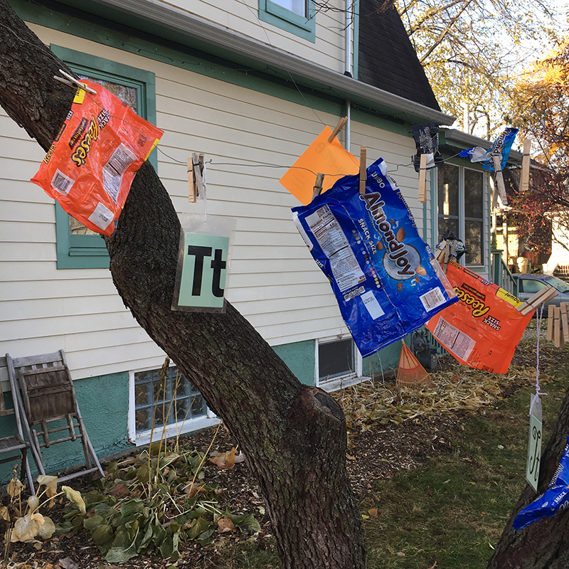 The letter T and candy bags (Halloween treats) hanging from tree